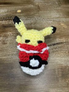 Crochet pikachu in poki ball pouch